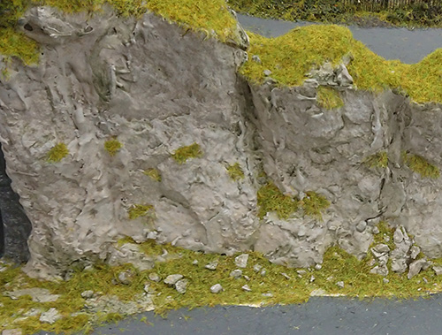 Green, grey, and brown painted rock face. Green, grey, and brown painted rock face.