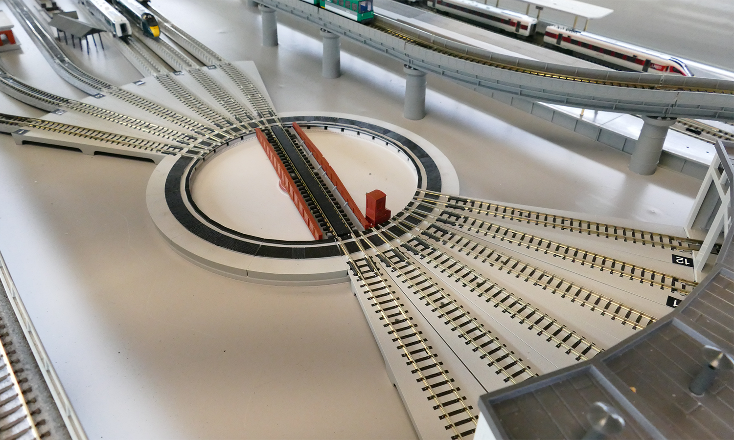 Click To Enlarge. A model railway set-up showing multiple tracks approaching a turntable from different directions