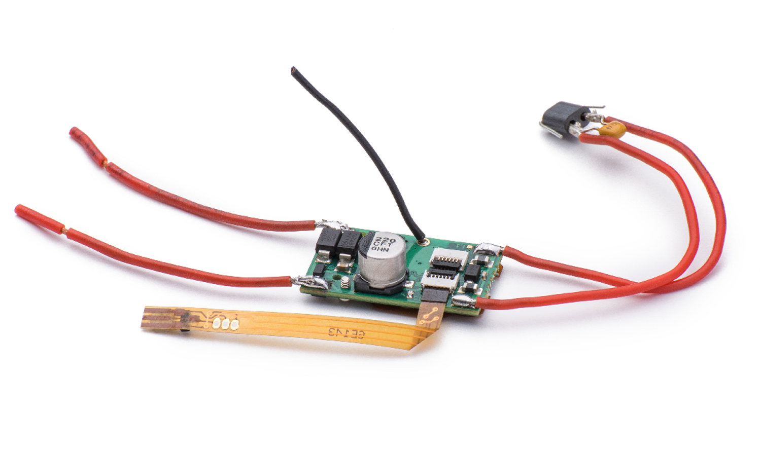 A close-up of a digital chip with red wires that are used to convert analogue slot cars to a digital system.