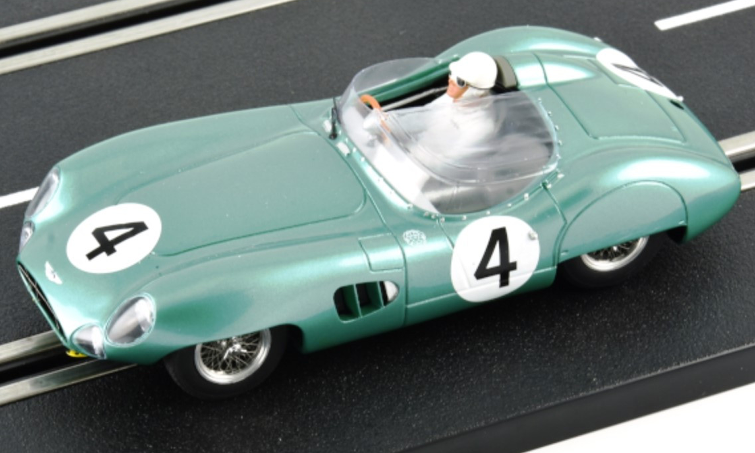 A mint green Le Mans Miniatures slot car displayed on a slot car race track.