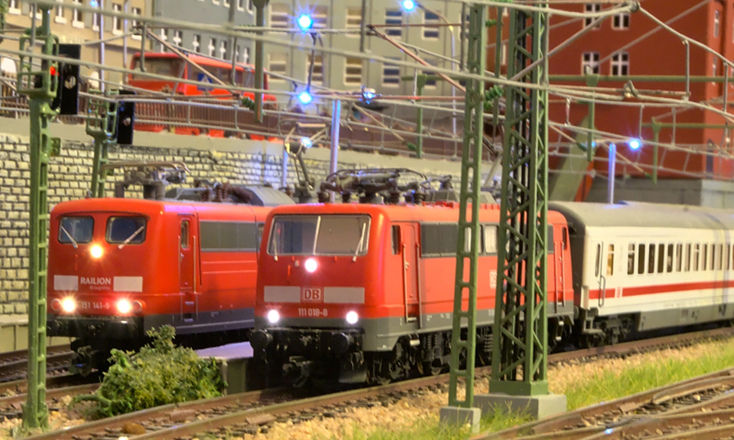 A picture of two model German locomotives in red