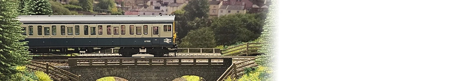 A model railway train crossing a bridge